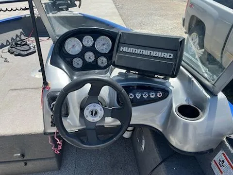 Slide: The Image of 2013 Tracker 175 Pro Guide boat dashboard with steering wheel and Humminbird fish finder. - 3