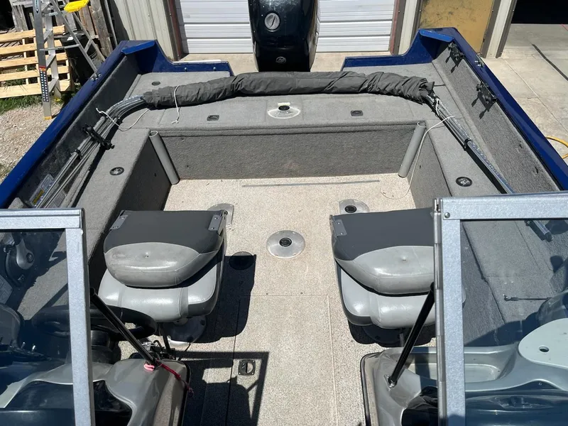 Slide: The Image of 2013 Tracker 175 Pro Guide boat interior with seating and storage compartments. - 6