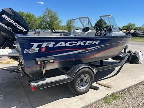 Slide: The Image of 2013 Tracker 175 Pro Guide boat on trailer, blue exterior, parked outdoors. - 7