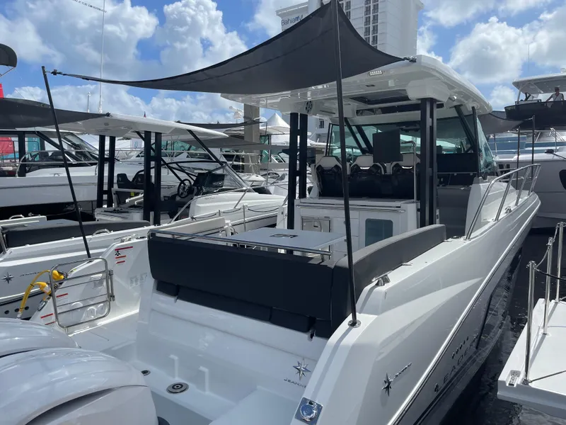 Slide: The Image of 2025 Jeanneau Leader 10.5 WA Series 2 boat docked under sunny skies. - 1