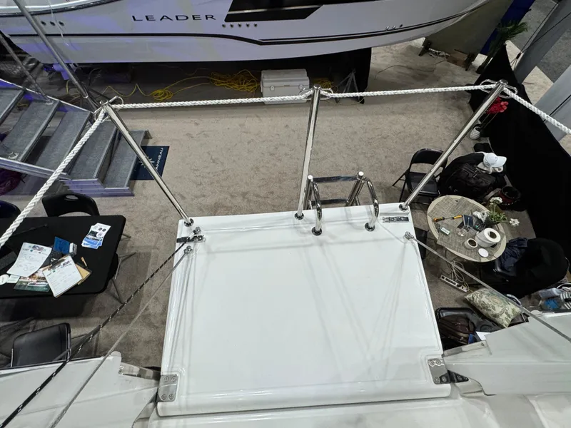 Slide: The Image of 2025 Jeanneau Leader 10.5 WA Series 2 boat deck at a showroom display. - 10