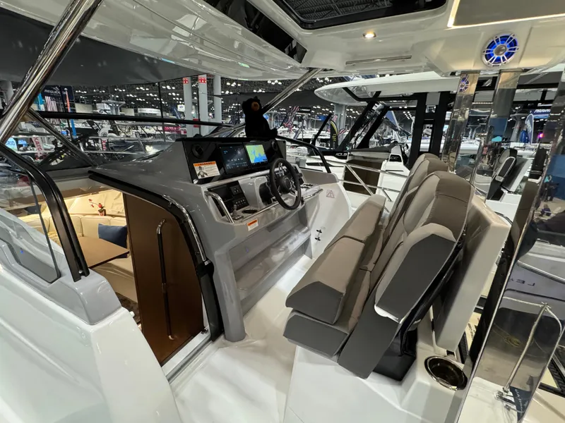 Slide: The Image of 2025 Jeanneau Leader 10.5 WA Series 2 boat interior with modern helm and seating. - 11
