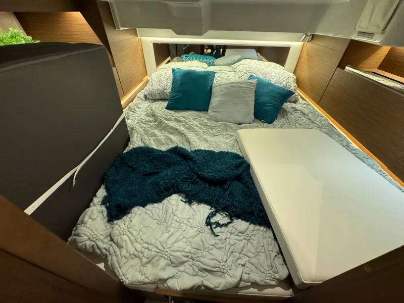 Slide: The Image of 2025 Jeanneau Leader 10.5 WA Series 2 cabin interior with cozy bedding and cushions. - 23