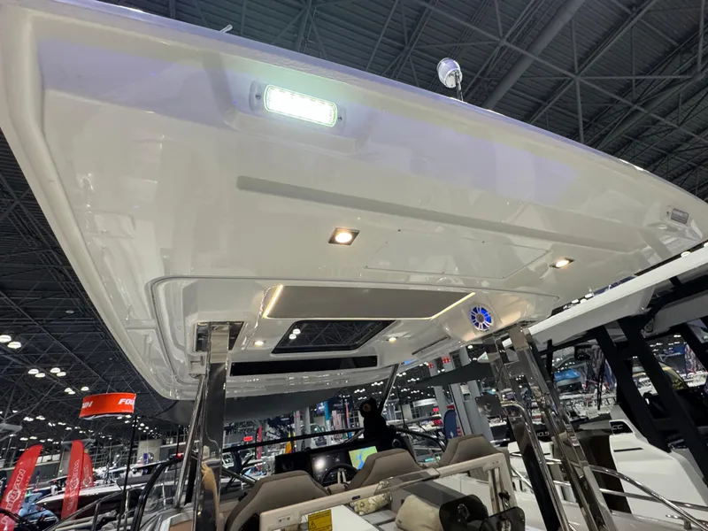 Slide: The Image of 2025 Jeanneau Leader 10.5 WA Series 2 boat interior at a showroom. - 7