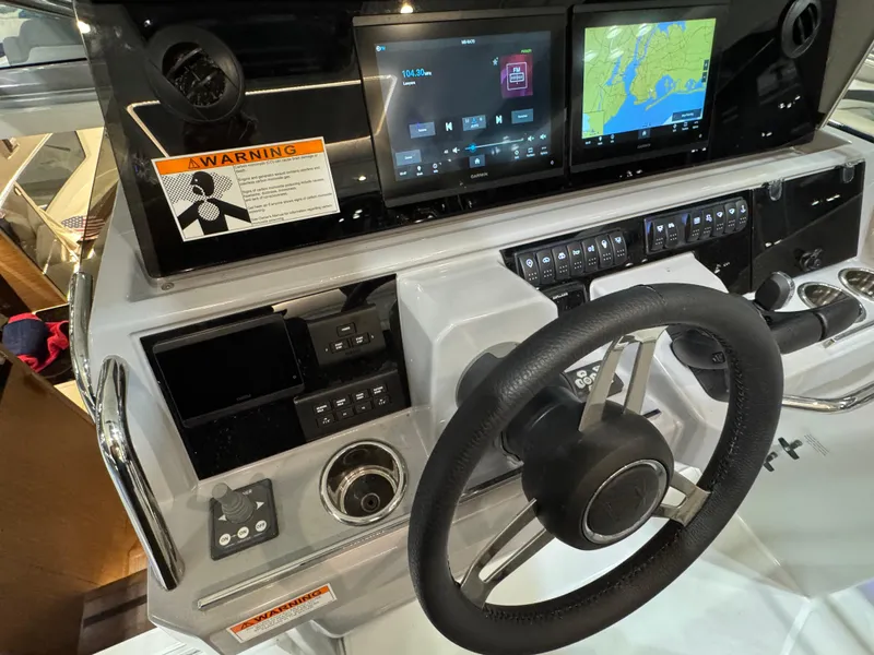 Slide: The Image of 2025 Jeanneau Leader 10.5 WA Series 2 helm with modern navigation displays. - 12