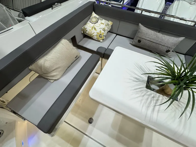 Slide: The Image of 2025 Jeanneau Leader 10.5 WA Series 2 interior with cushioned seating and table. - 6