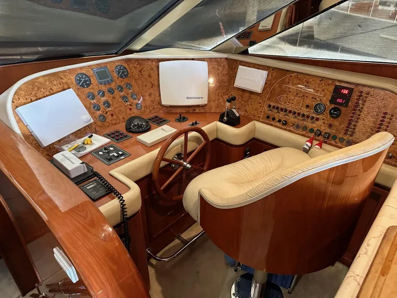 Slide: The Image of Luxurious 2001 Johnson 70 yacht cockpit with wood finish and advanced navigation controls. - 10