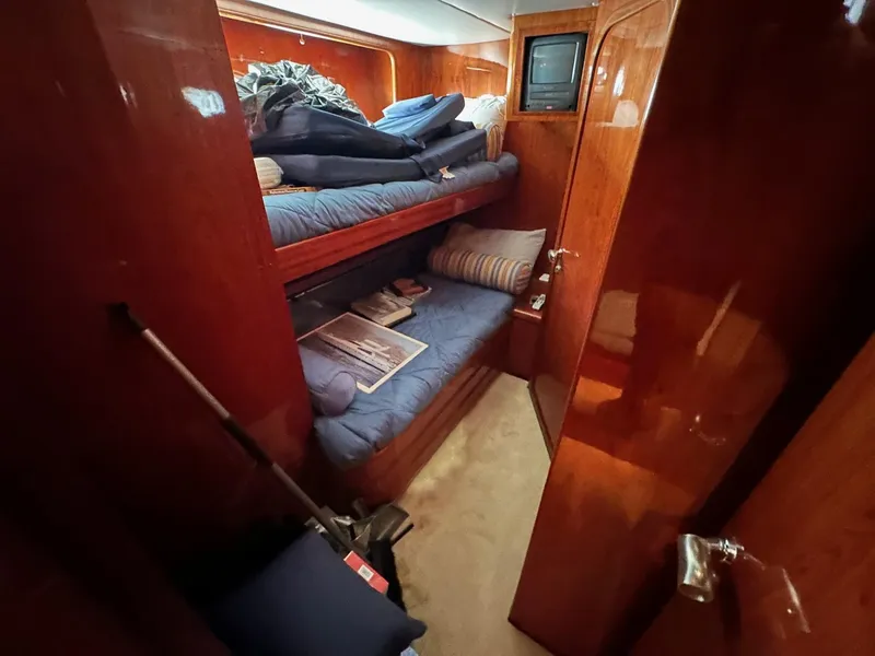 Slide: The Image of Cozy cabin interior of 2001 Johnson 70 yacht with bunk beds and wooden finish. - 16