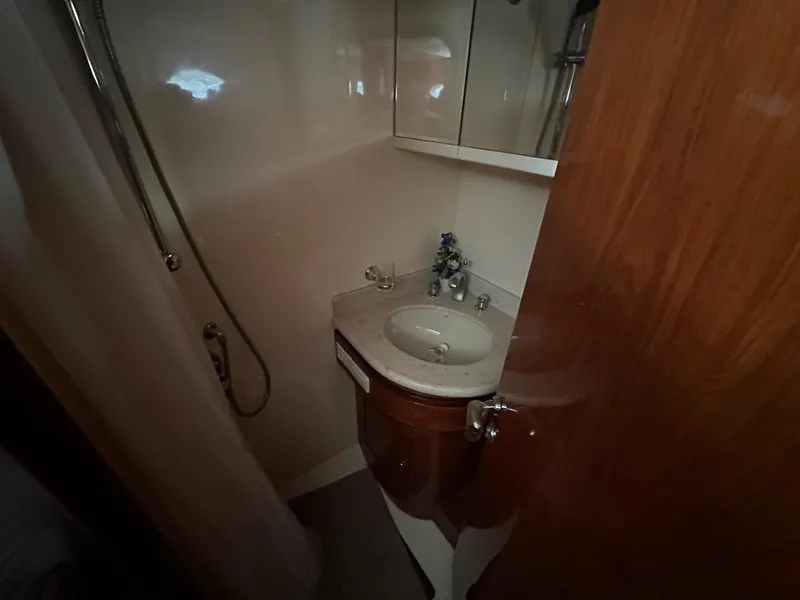 Slide: The Image of Compact bathroom in a 2001 Johnson 70 yacht with sink and shower. - 17