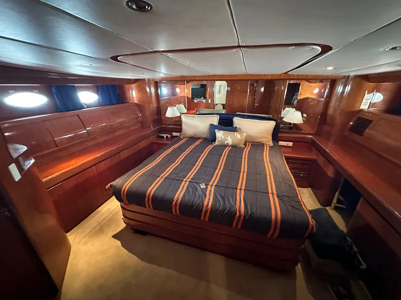 Slide: The Image of Luxurious cabin interior of 2001 Johnson 70 yacht with wood paneling and cozy bedding. - 19
