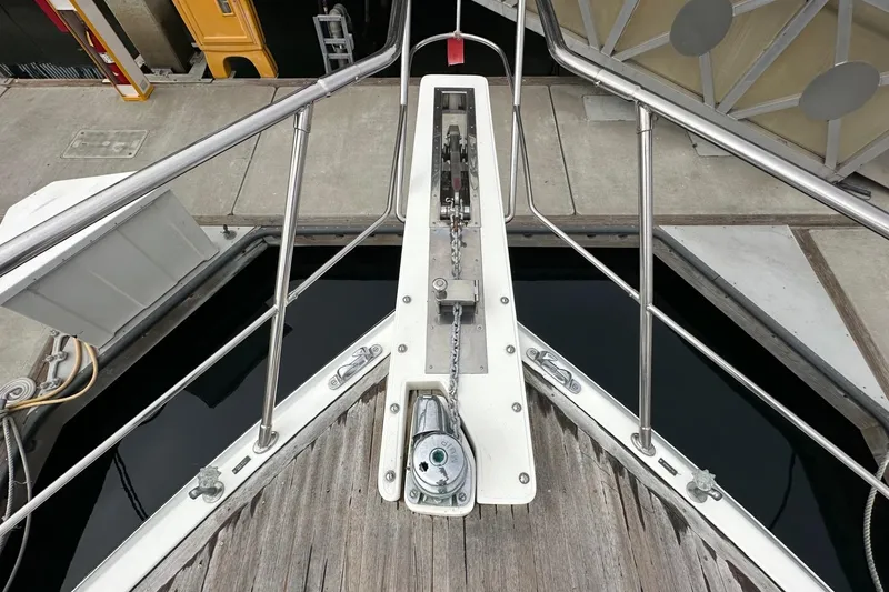Slide: The Image of Bow of a 2001 Johnson 70 yacht with anchor chain and dock view. - 2