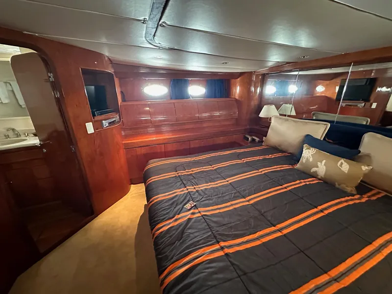 Slide: The Image of Luxurious cabin interior of 2001 Johnson 70 yacht with cozy bed and wooden furnishings. - 21
