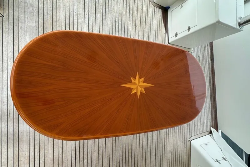 Slide: The Image of Elegant wooden table with star inlay on a Johnson 70 yacht, 2001 model. - 24