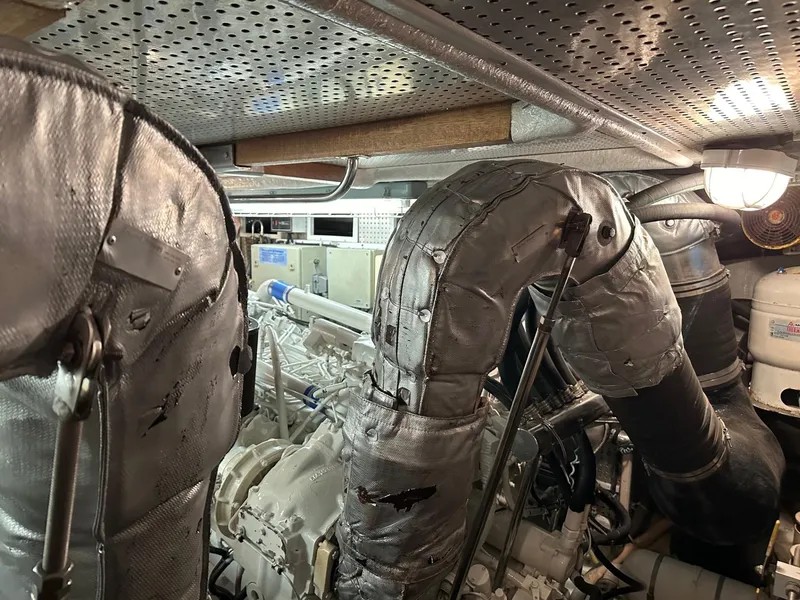 Slide: The Image of Engine room of a 2001 Johnson 70 yacht with insulated exhaust pipes. - 25