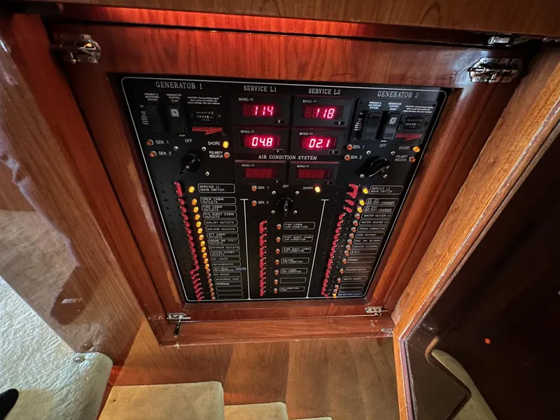 Slide: The Image of Electrical control panel on a 2001 Johnson 70 yacht, featuring generator and service indicators. - 28