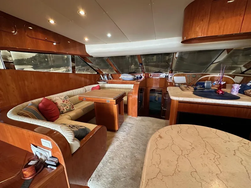 Slide: The Image of Luxurious interior of a 2001 Johnson 70 yacht with elegant wood finishes and plush seating. - 29