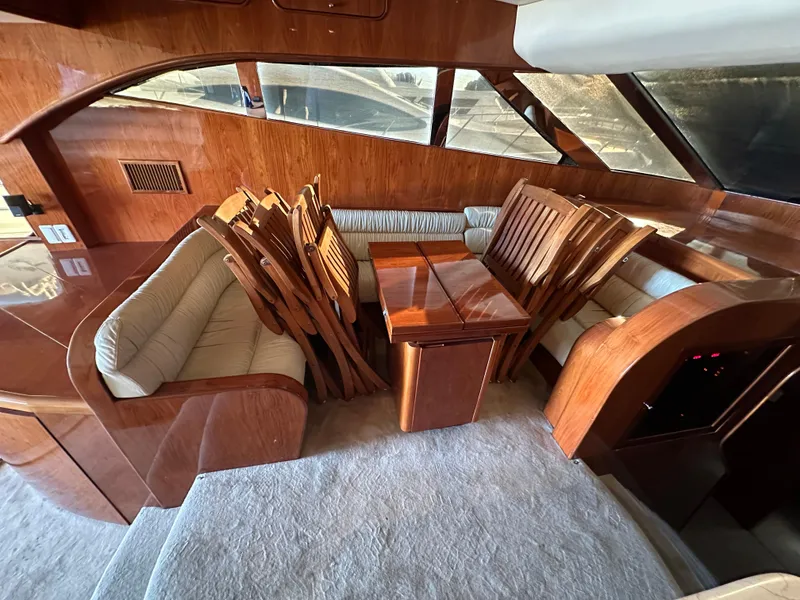 Slide: The Image of Luxurious wooden interior of a 2001 Johnson 70 yacht with dining area. - 32