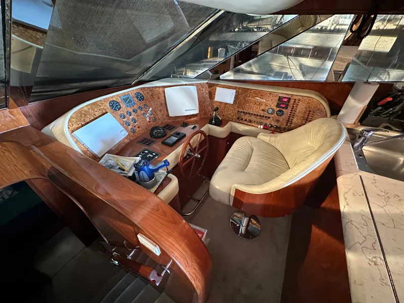 Slide: The Image of Luxurious 2001 Johnson 70 yacht cockpit with wood paneling and plush seating. - 33