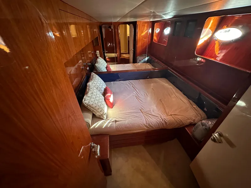Slide: The Image of Luxurious cabin interior of 2001 Johnson 70 yacht with wooden finish and cozy bedding. - 35