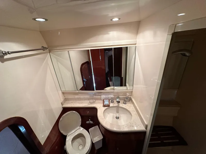Slide: The Image of Luxurious yacht bathroom with marble sink, mirror, and toilet in a 2001 Johnson 70 model. - 36