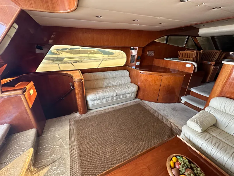 Slide: The Image of Luxurious interior of a 2001 Johnson 70 yacht with elegant wood finishes and plush seating. - 38