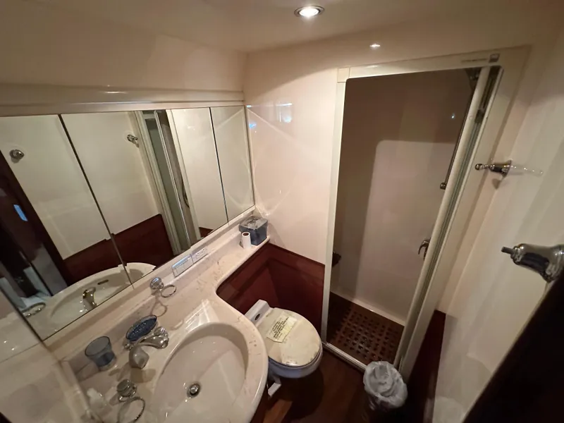 Slide: The Image of Compact bathroom in a 2001 Johnson 70 yacht with shower and sink. - 39