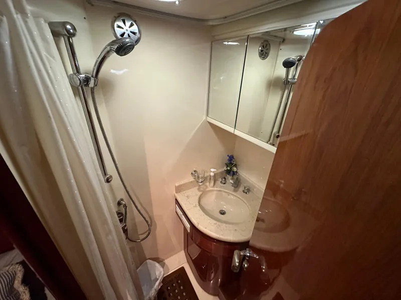 Slide: The Image of Compact bathroom in a 2001 Johnson 70 yacht with shower and sink. - 41