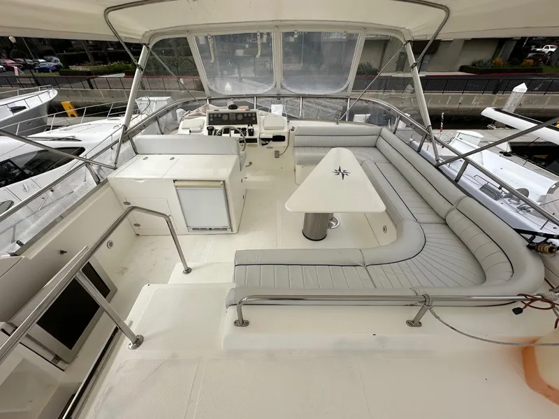 Slide: The Image of Spacious deck of 2001 Johnson 70 yacht with seating and table. - 6