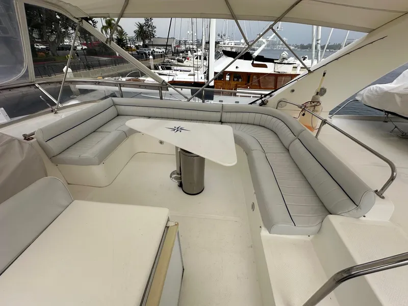 Slide: The Image of Spacious seating area on 2001 Johnson 70 yacht with marina view. - 7