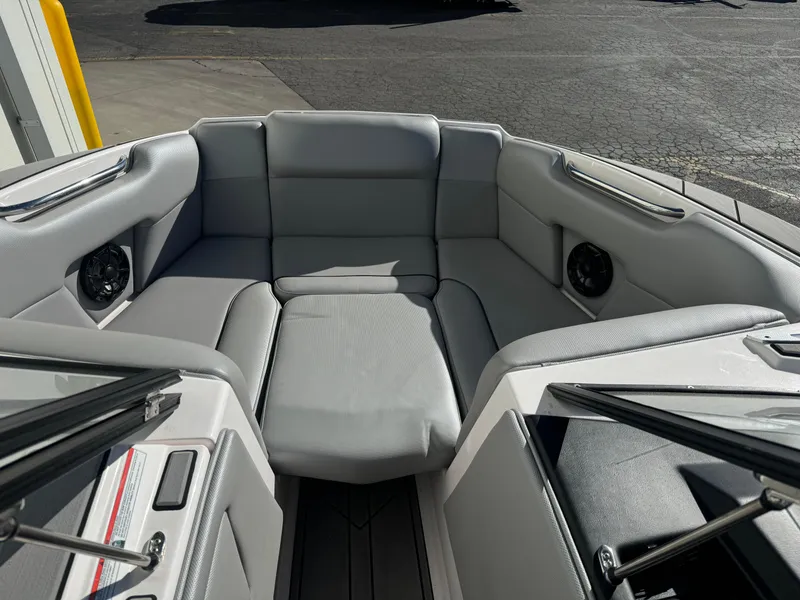 Slide: The Image of 2022 Moomba Mondo boat interior with gray seating and speakers. - 10