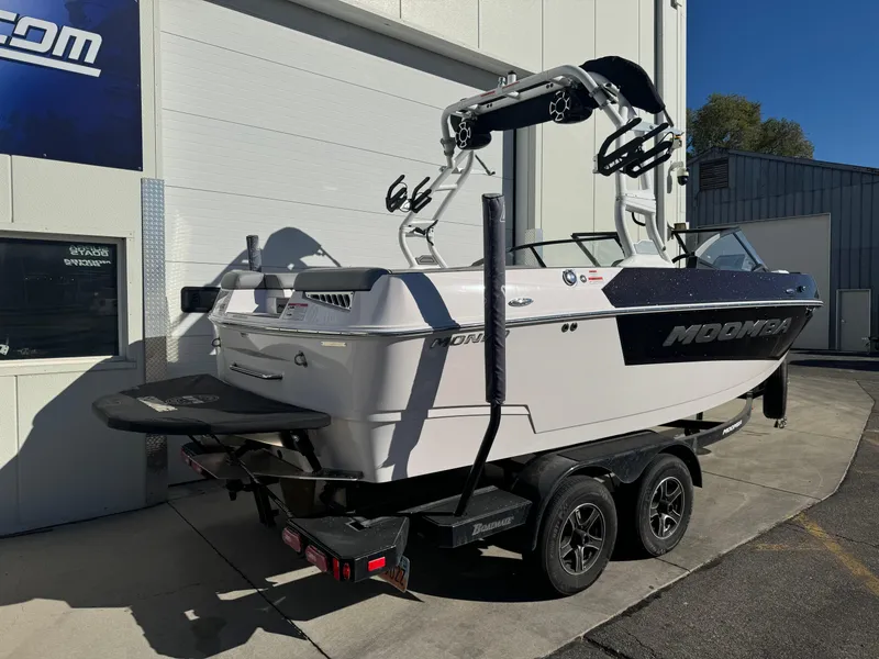 Slide: The Image of 2022 Moomba Mondo boat on trailer, parked outside a building. - 2