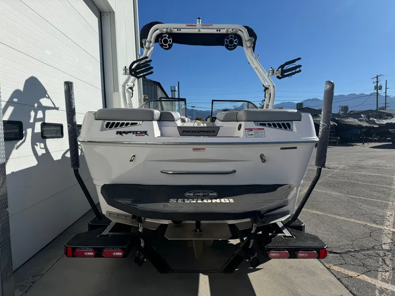 Slide: The Image of 2022 Moomba Mondo boat rear view, parked outdoors near a building. - 4