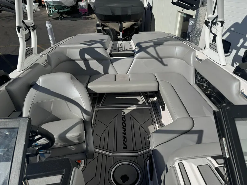Slide: The Image of 2022 Moomba Mondo boat interior with gray seating and modern design. - 7