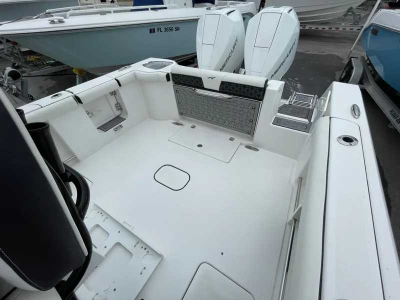 Slide: The Image of 2021 Tidewater 272 CC Adventure boat interior with spacious deck and twin engines. - 15