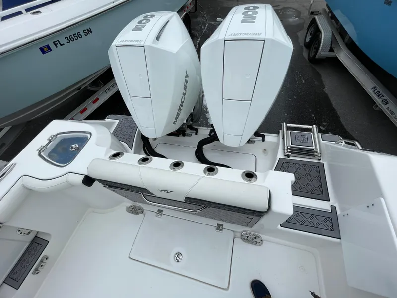 Slide: The Image of 2021 Tidewater 272 CC Adventure boat with dual Mercury outboard engines. - 17