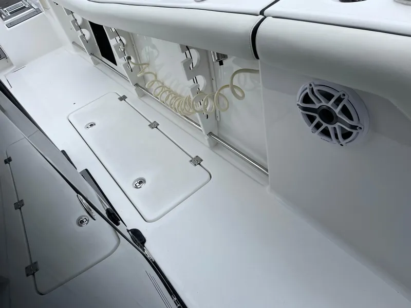 Slide: The Image of 2021 Tidewater 272 CC Adventure boat deck with storage compartments and speaker. - 6