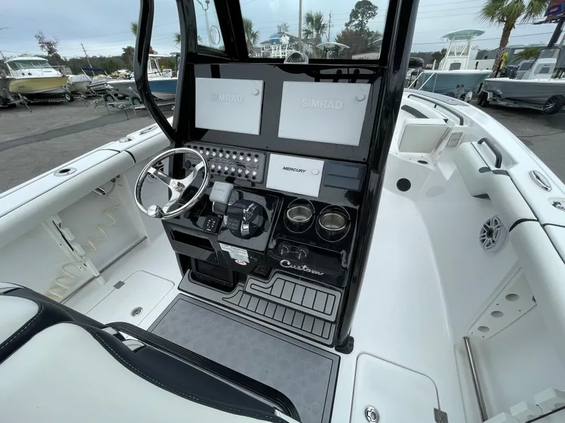 Slide: The Image of 2021 Tidewater 272 CC Adventure boat cockpit with modern controls and dual screens. - 8