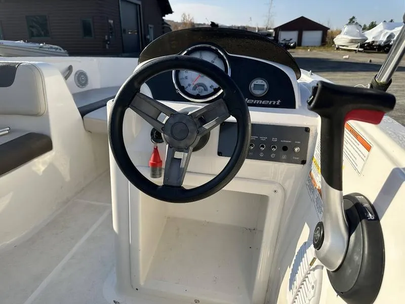 Slide: The Image of 2019 Bayliner E16 boat steering console with controls and gauges. - 3