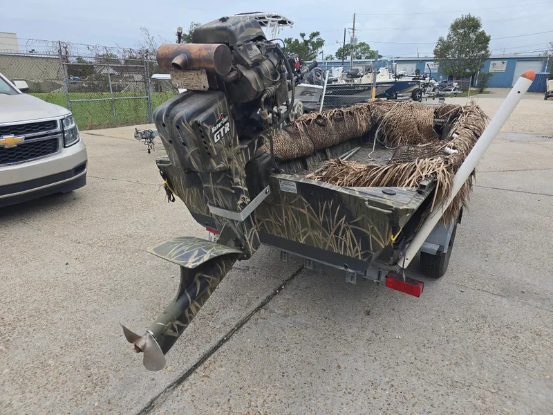 Slide: The Image of Camouflaged 2016 Custom Shallow 16 boat with outboard motor on trailer. - 3