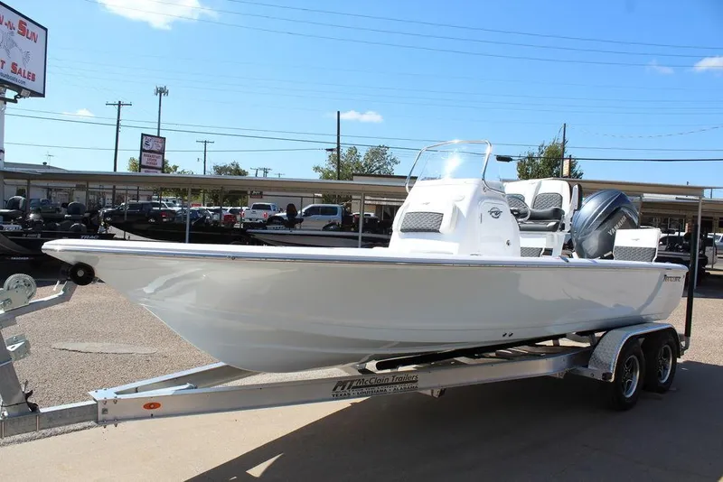 Slide: The Image of 2025 Tidewater 2110 Bay Max boat on trailer, displayed outdoors under clear sky. - 10