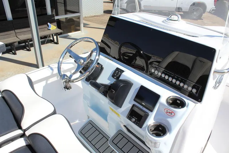 Slide: The Image of 2025 Tidewater 2110 Bay Max boat console with steering wheel and controls. - 18