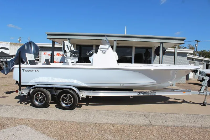 Slide: The Image of 2025 Tidewater 2110 Bay Max boat on trailer, parked outdoors. - 2