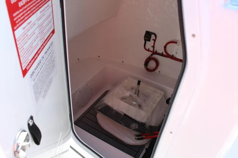 Slide: The Image of 2025 Tidewater 2110 Bay Max storage compartment with equipment and wiring. - 25