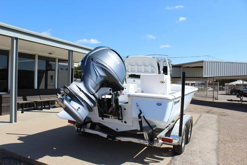 Slide: The Image of 2025 Tidewater 2110 Bay Max boat on trailer, featuring powerful outboard motor. - 4