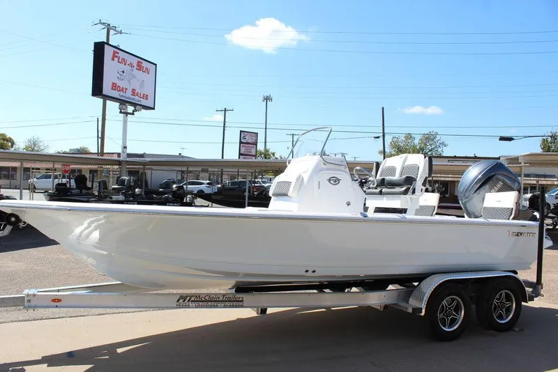 Slide: The Image of 2025 Tidewater 2110 Bay Max boat on trailer at dealership, sunny day. - 8