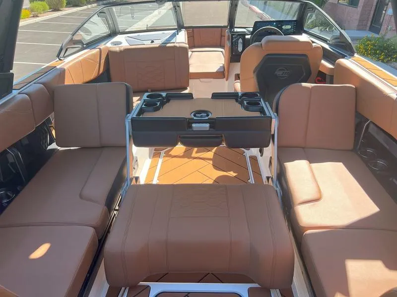 Slide: The Image of 2025 Malibu 23 LSV boat interior with luxurious tan seating and modern design. - 14