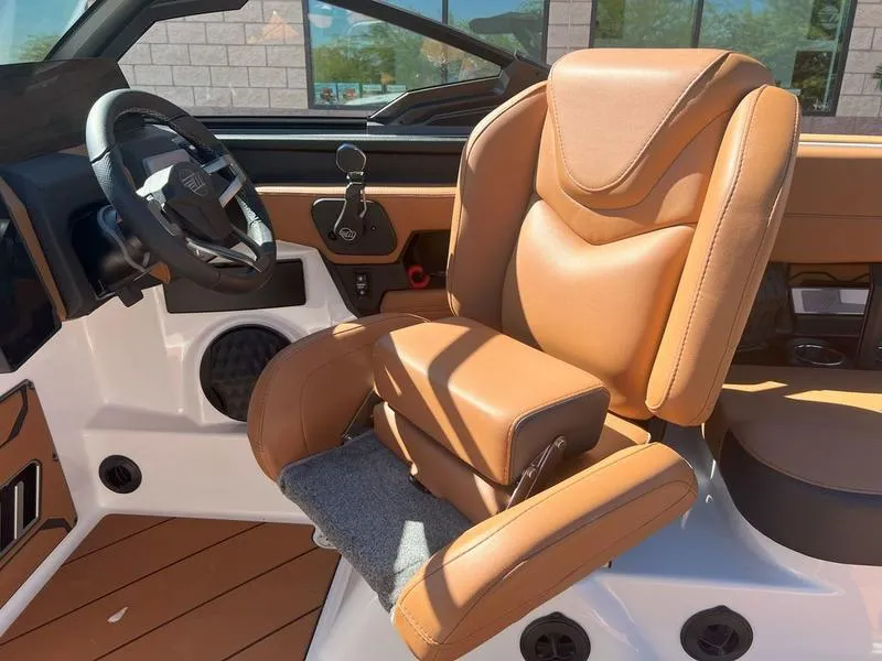 Slide: The Image of 2025 Malibu 23 LSV boat interior with luxurious tan leather seating and modern dashboard. - 15