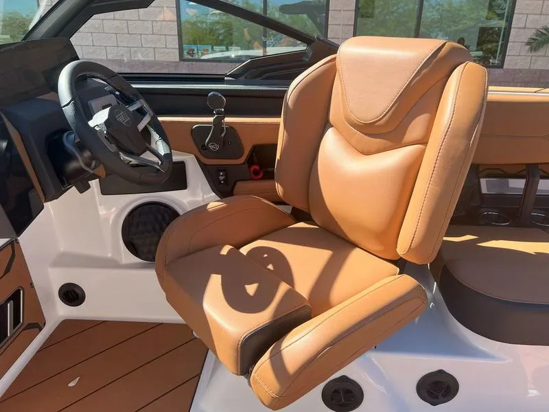 Slide: The Image of 2025 Malibu 23 LSV boat interior with luxurious tan leather seating. - 16