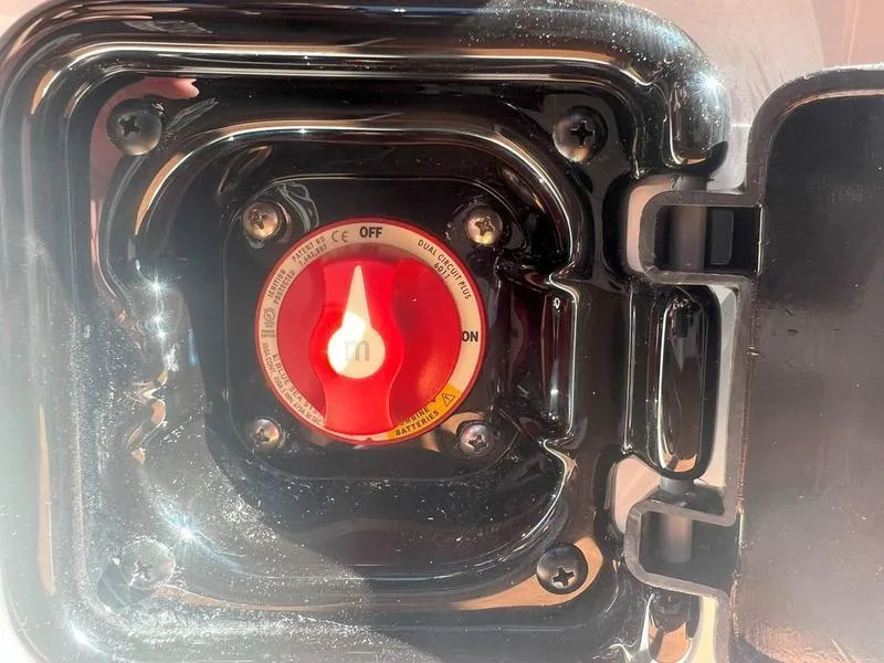 Slide: The Image of Close-up of a 2025 Malibu 23 LSV boat battery switch in the "off" position. - 19