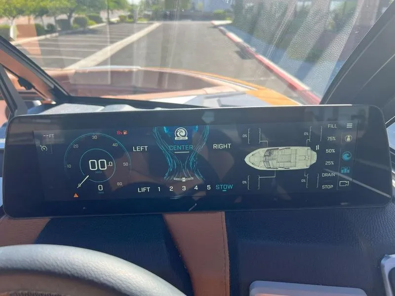 Slide: The Image of 2025 Malibu 23 LSV dashboard display with navigation and control settings. - 23